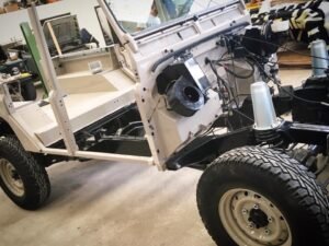 The chassis of a Land Rover Defender being meticulously restored in the workshop.